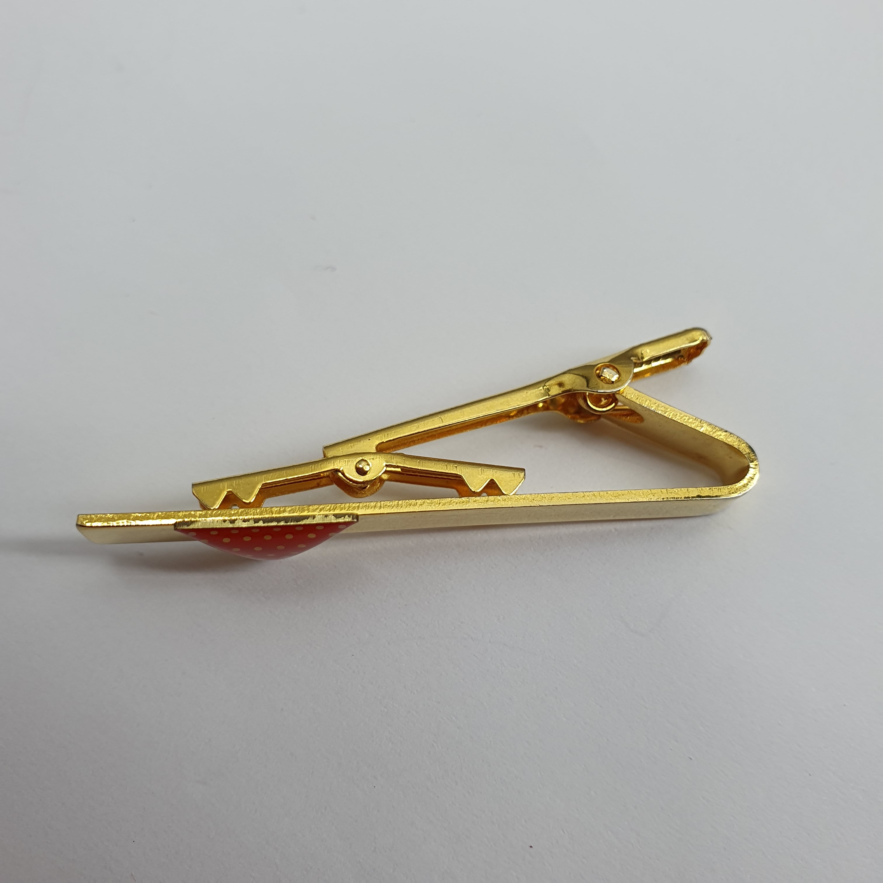Gold-colored tie clip from the 90s, red triangle