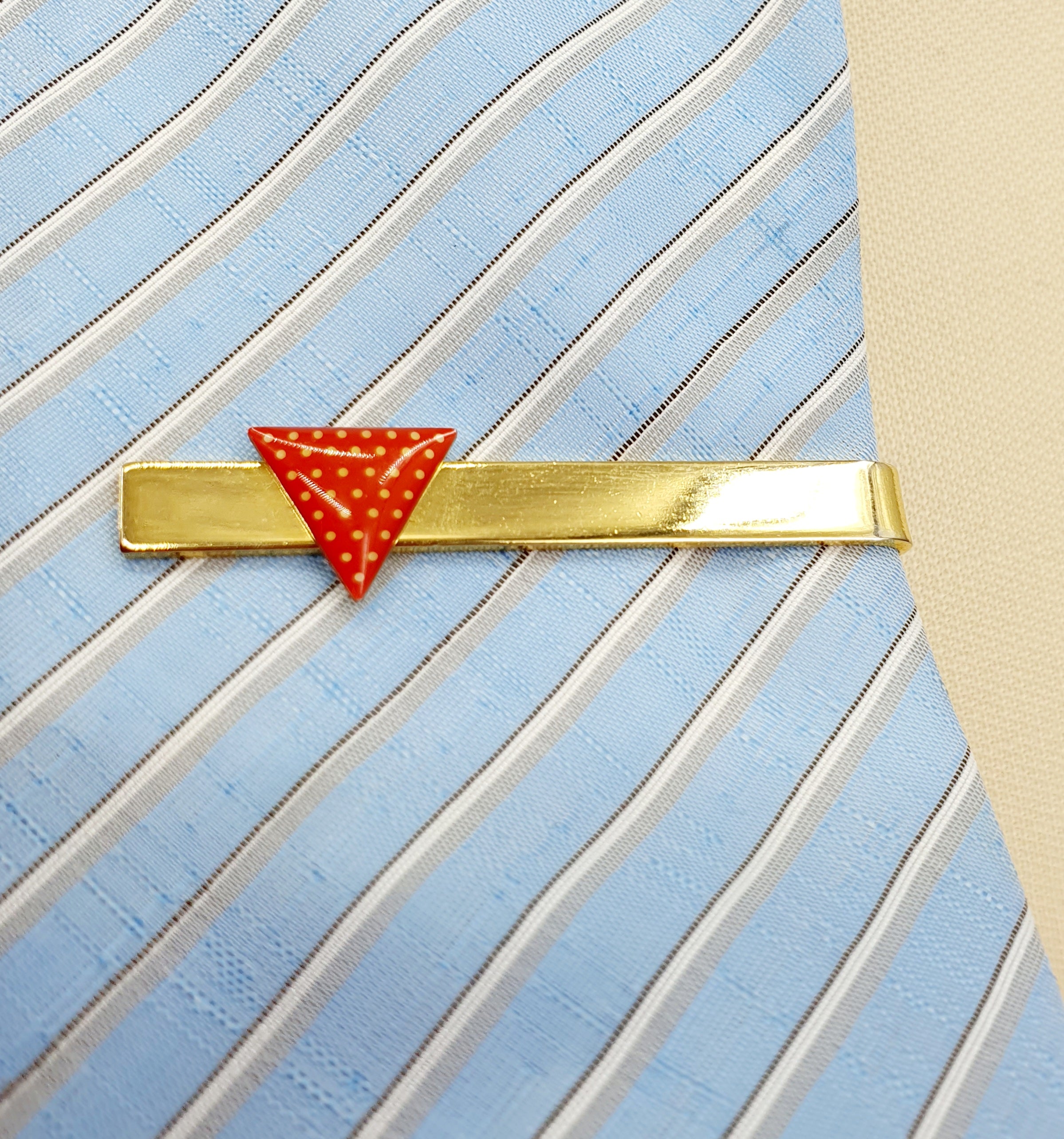 Gold-colored tie clip from the 90s, red triangle