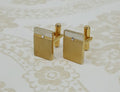 Gold-colored cufflinks with a small rhinestone